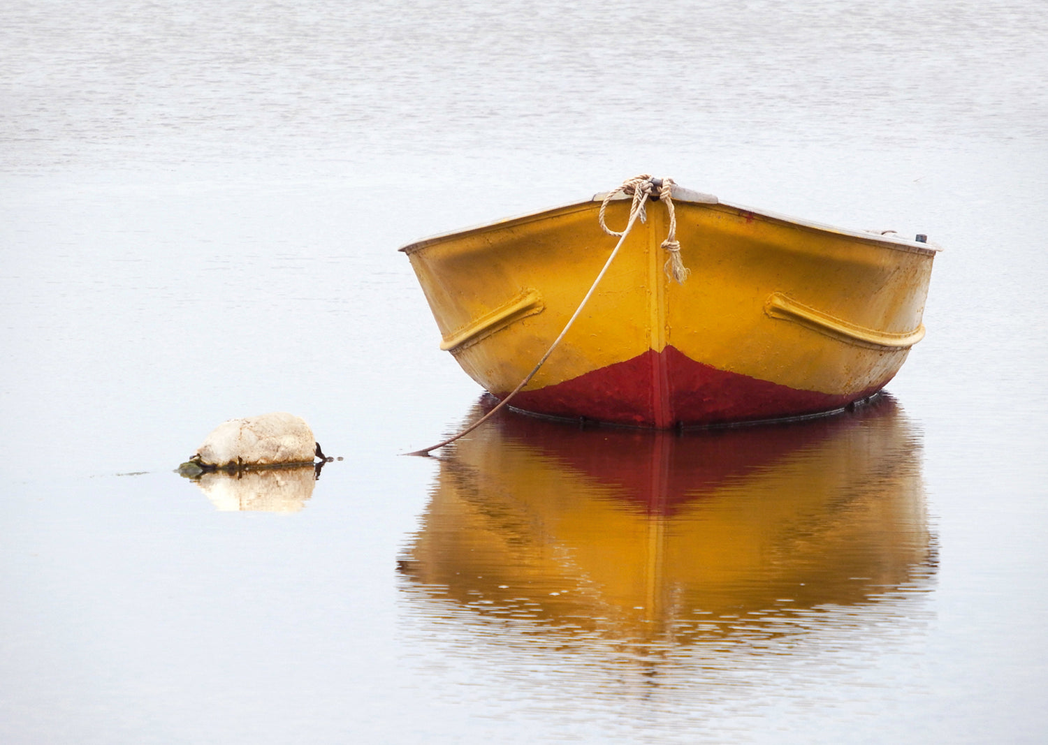 Yellow and red boat floating on a lake in Canada. Fine Art Photography. Kristen Olivares