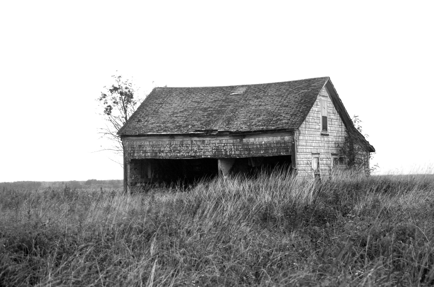 An old abandoned barn off in the desolate fields of Canada. Framed fine art photography by Kristen Olivares.
