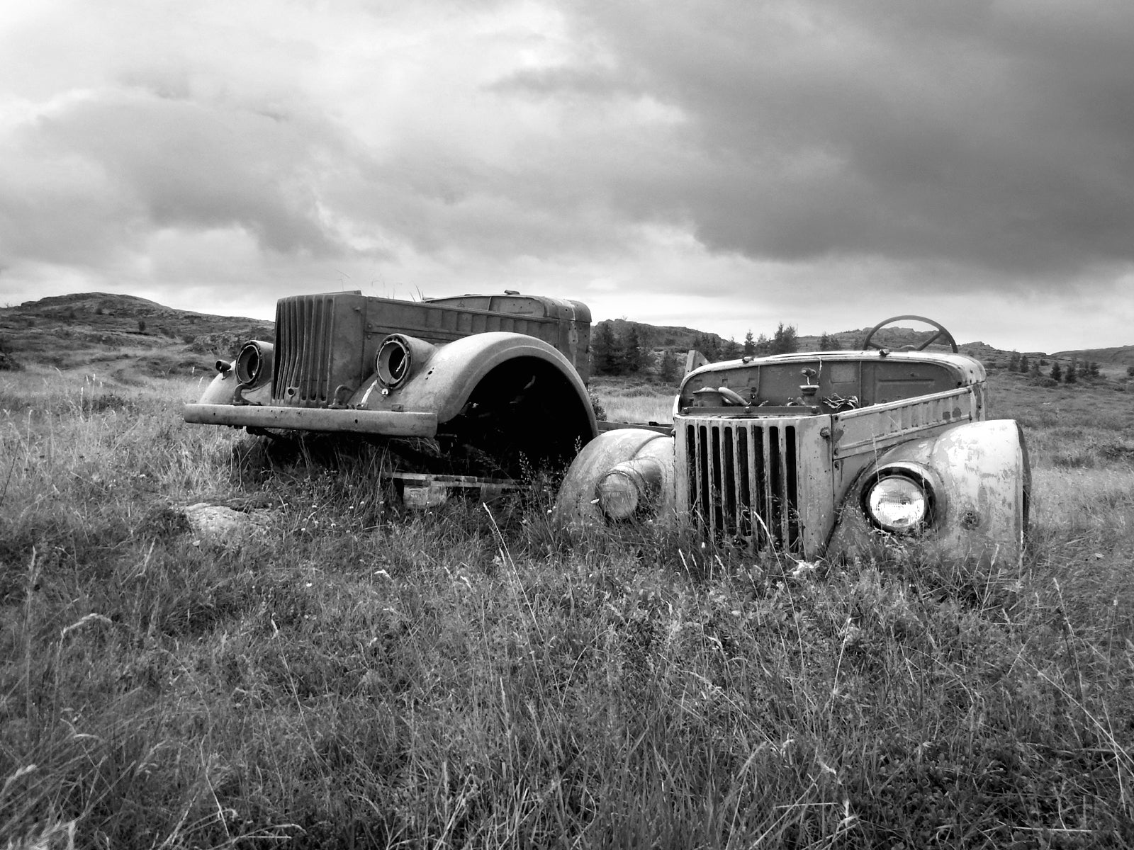 Beautiful, abandoned, antique cars left out in a field in Iceland. Black and white Fine art photography by Kristen Olivares. 