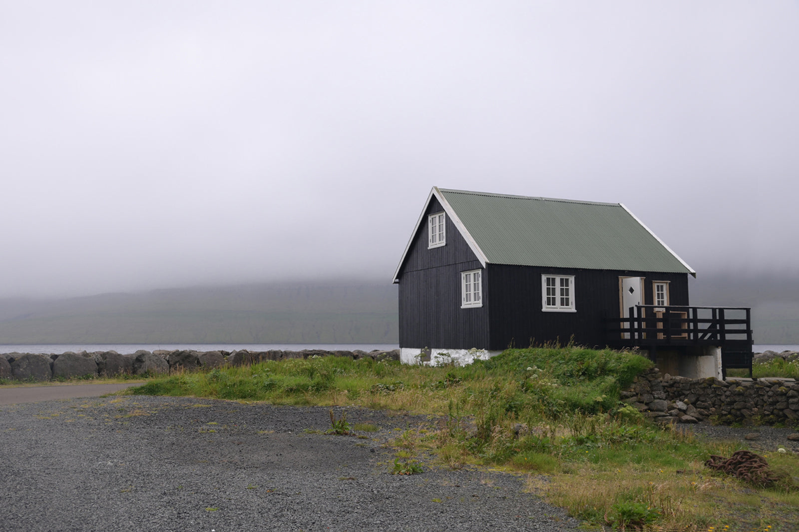 A beautiful lone home on the coast of the Faroe Islands. Fine Art Photography by Kristen Olivares.
