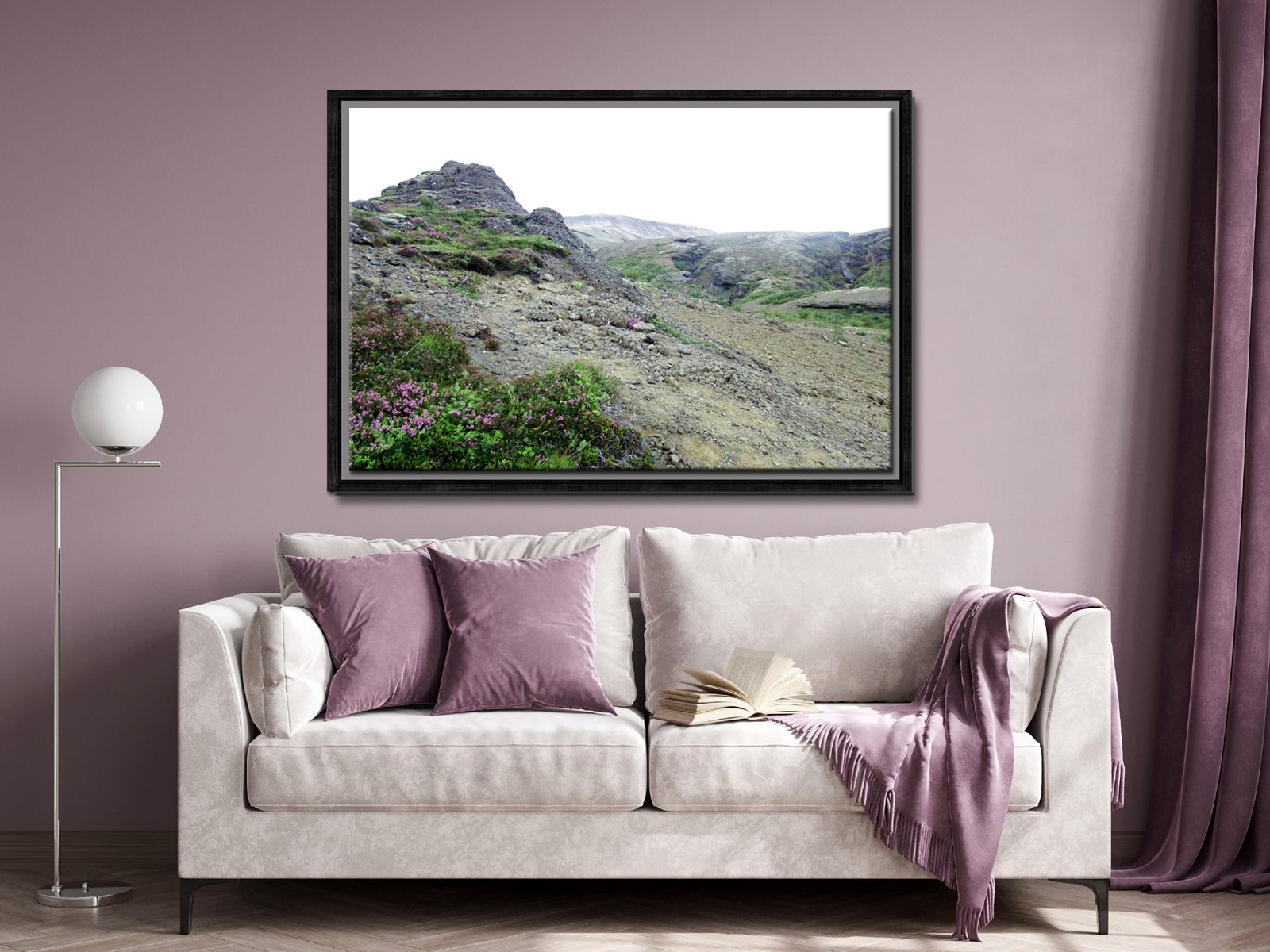 Icelands rough, rugged landscape with delicate pink flowers growing along side the rocky land. Framed fine art photography by Kristen Olivares. 