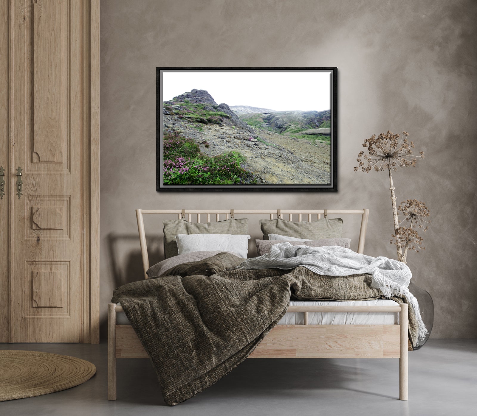 Icelands rough, rugged landscape with delicate pink flowers growing along side the rocky land. Framed fine art photography by Kristen Olivares. 