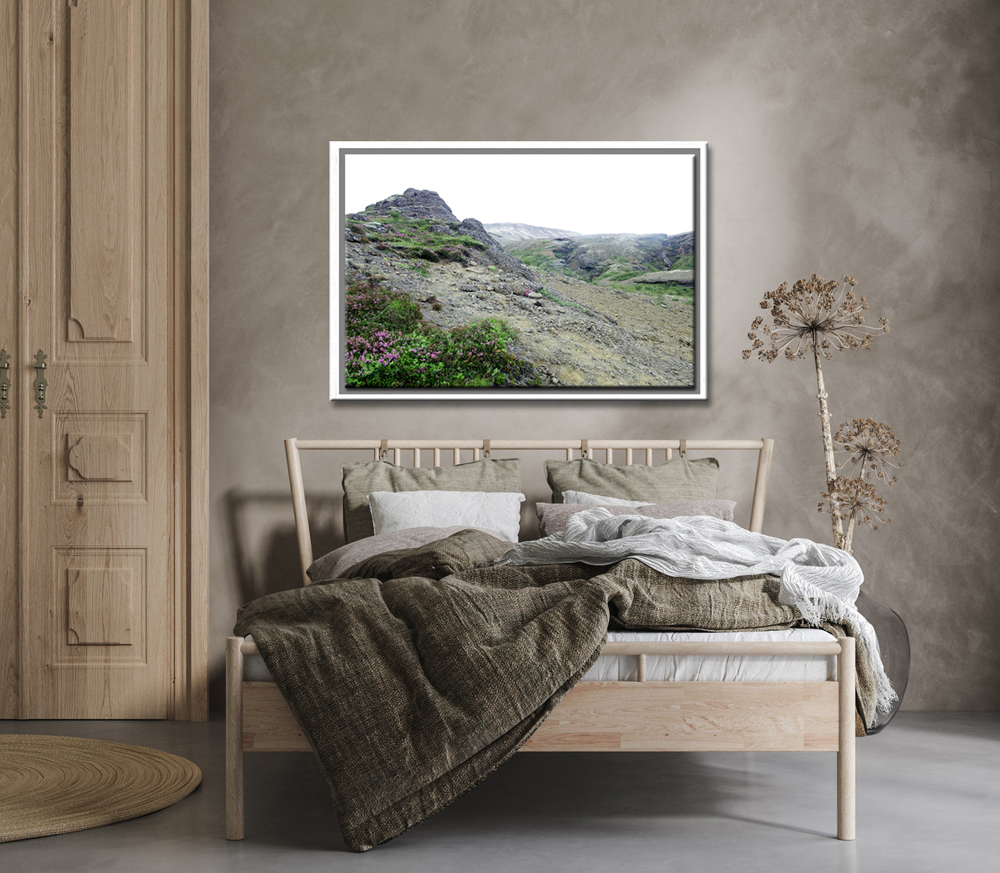 Icelands rough, rugged landscape with delicate pink flowers growing along side the rocky land. Framed fine art photography by Kristen Olivares. 