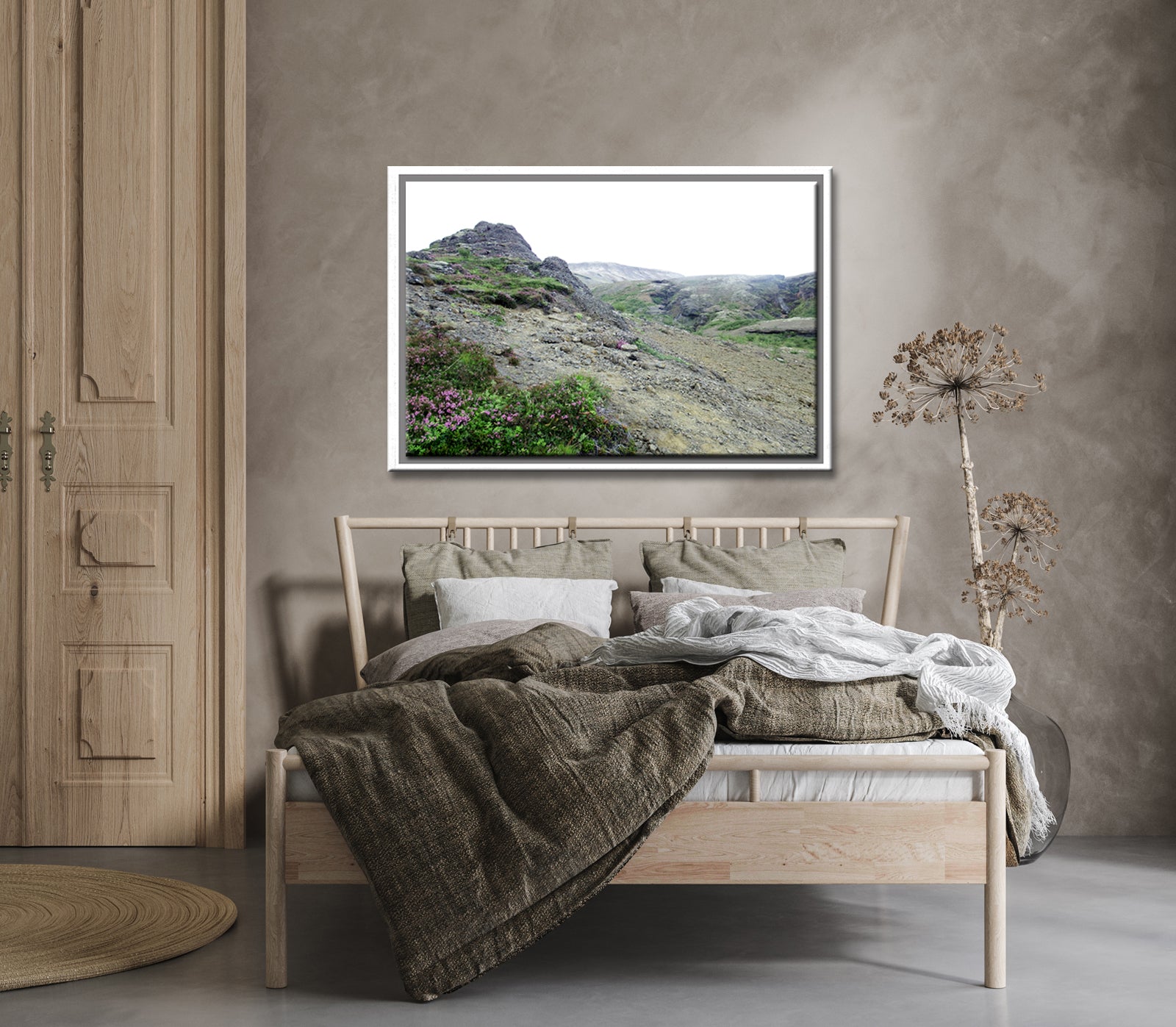 Icelands rough, rugged landscape with delicate pink flowers growing along side the rocky land. Framed fine art photography by Kristen Olivares. 