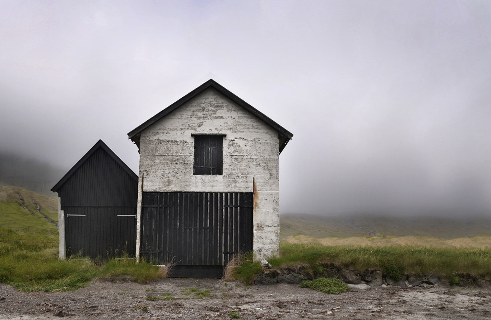 Old, stone fishing shacks on the coast of the Faroe Islands.  Fine Art Photography. Kristen Olivares
