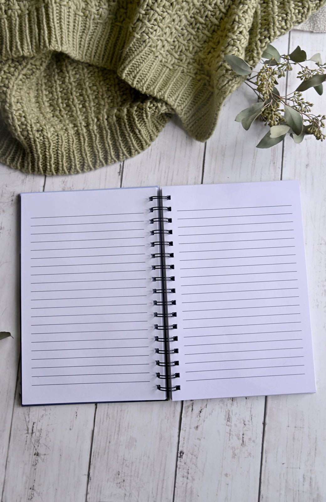 Opened hardcover journal, showing lined pages. 200 pages, spiral bound. 