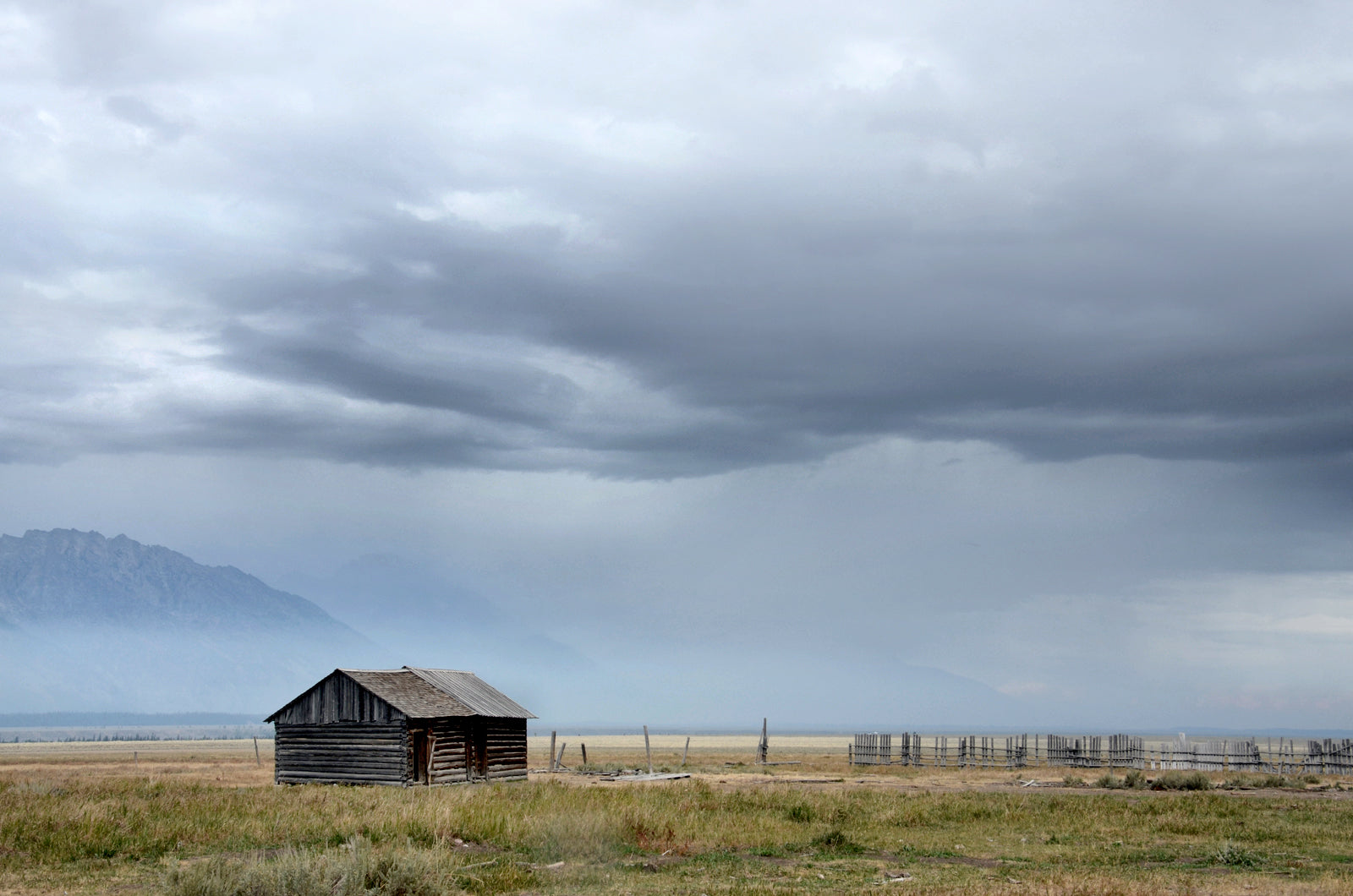 Little log cabin tucked away among the stunning Grand Teton mountains. Canvas Wall Art Framed Fine Art photography by Kristen Olivares.