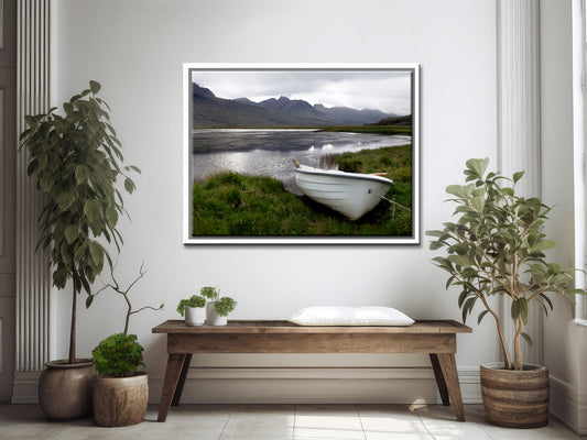 A beautiful little white row boat pulled up upon the desolate shore of Iceland. Framed canvas wall art. Fine art photography by Kristen Olivares. 