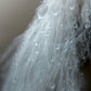 A beautiful white feather covered in rain drops. Framed fine art photography by Kristen Olivares.