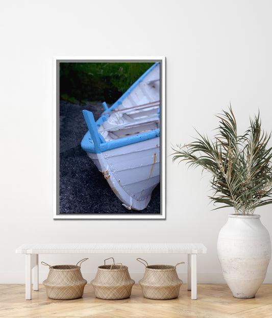 An old white wooden boat pulled ashore in the Faroe Islands. Framed fine art photography by Kristen Olivares.